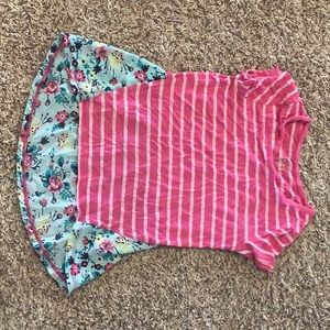 A pink striped shirt with blue and yellow flowers